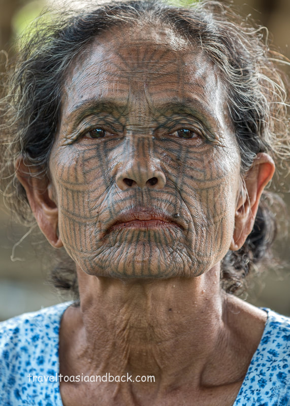 traveltoasiaandback.com - A tattooed Chin woman poses for a picture in Pan Paung, Rakhine State, Myanmar