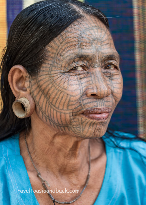 A tattooed lady from Pan Paung Village poses for a photo, Chin State, Myanmar